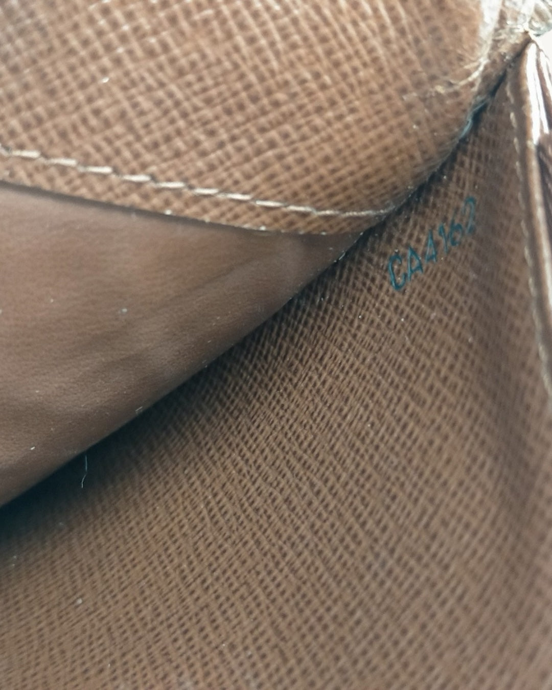 Close-up of CA4162 date code inside brown Louis Vuitton wallet pocket