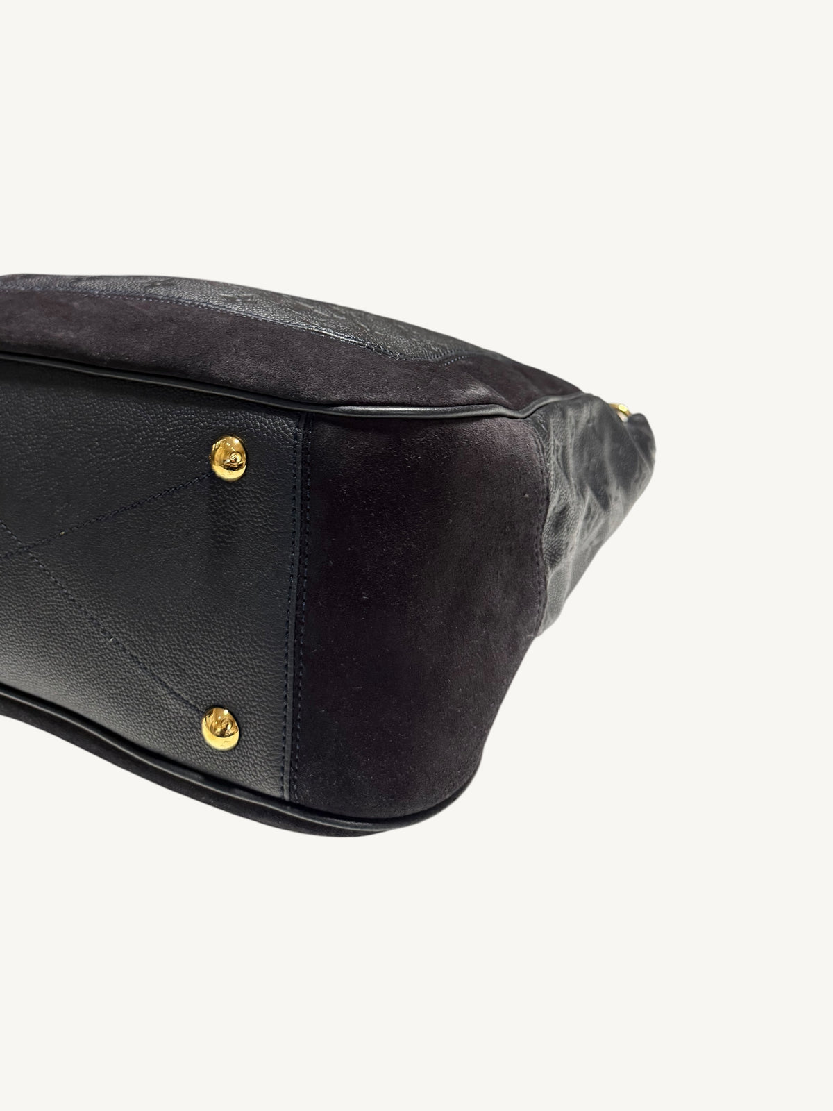 Louis Vuitton Audacieuse MM Infini — close-up back corner and base showing gold feet and suede-to-leather contrast