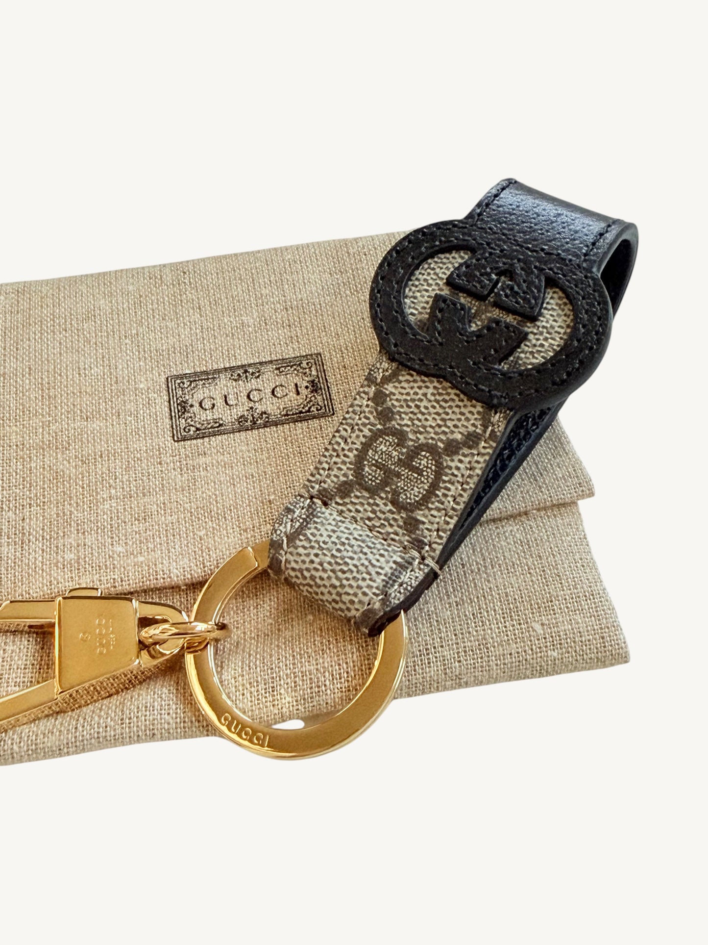Gucci Interlocking G Key Ring Bag Charm — front view showing embossed oval Interlocking G emblem | Shimmer & Shawls