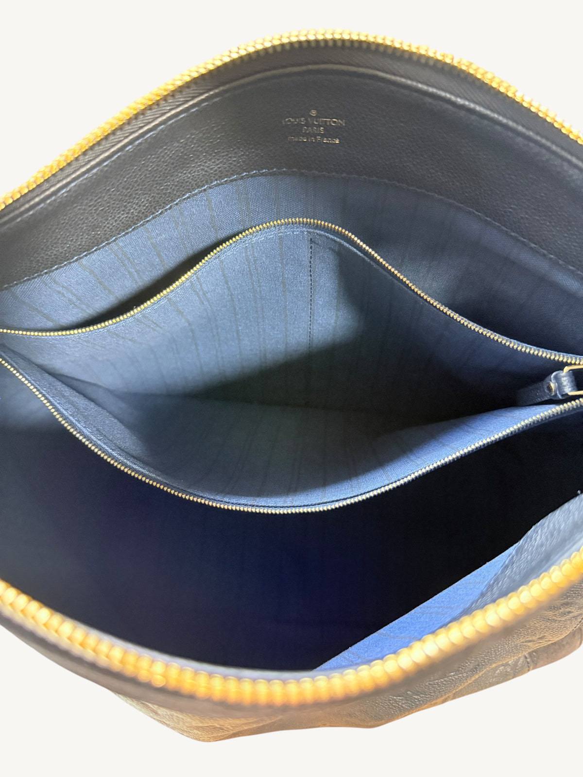 Louis Vuitton Audacieuse MM Infini — interior open showing blue striped canvas lining and gold-tone interior zipper pocket