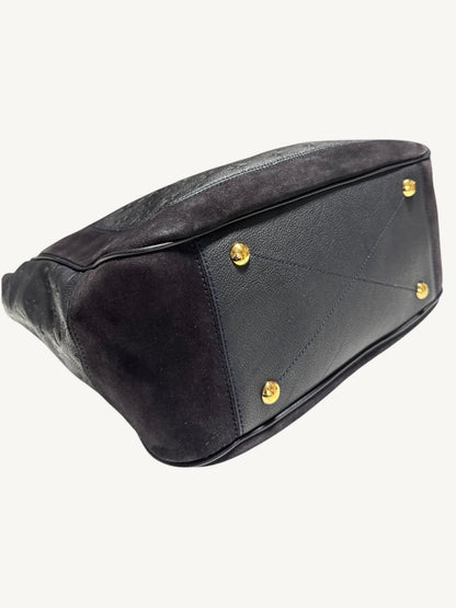 Louis Vuitton Audacieuse MM Infini — close-up back corner and base showing gold feet and suede-to-leather contrast