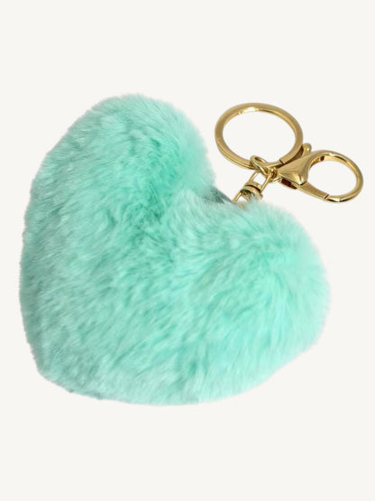 A mint green faux fur heart-shaped keychain with a gold-tone metal split ring and clasp, shown on a plain off-white background.