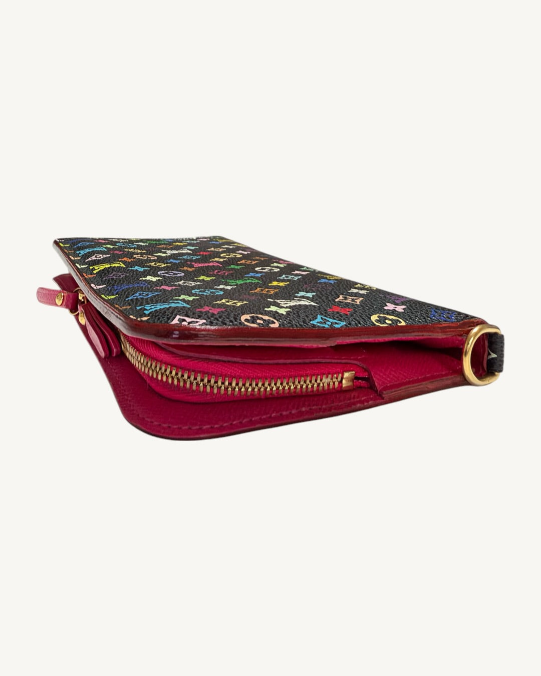 Angled side view of the black Multicolore Insolite wallet showing pink leather interior, zipper and gold-tone D-ring.