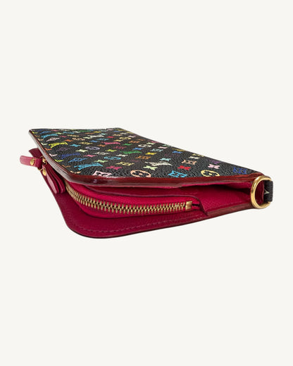 Angled side view of the black Multicolore Insolite wallet showing pink leather interior, zipper and gold-tone D-ring.