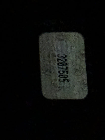 A small rectangular light gray tag or label with rounded corners, showing the HOLOGRAM printed number 3207505 in black on a dark background.