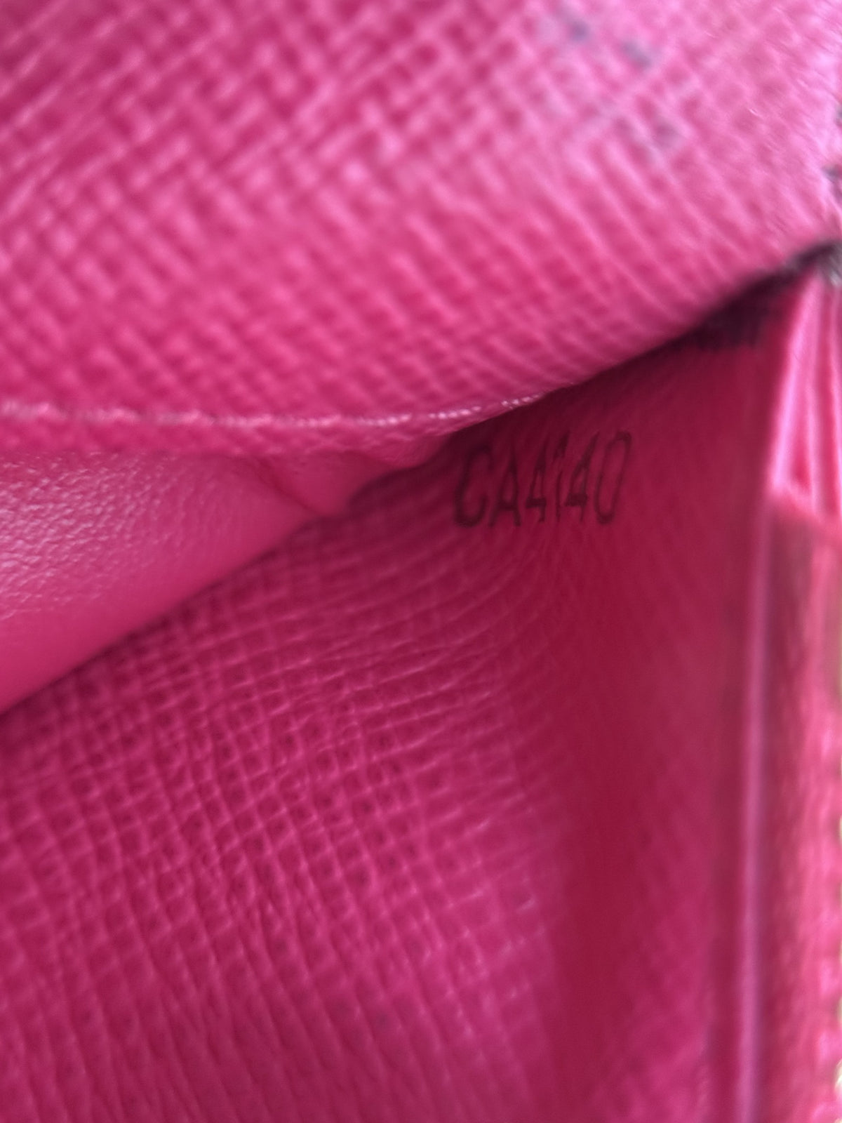 Louis Vuitton Insolite wallet date code CA4140 stamped inside the Grenade pink leather lining.