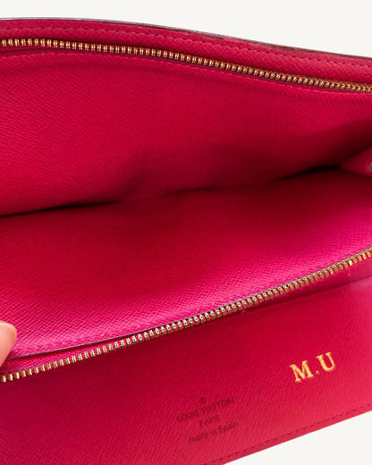 Open pink leather compartment with gold-tone zipper, Louis Vuitton Made in Spain stamp and gold-foil M.U initials.