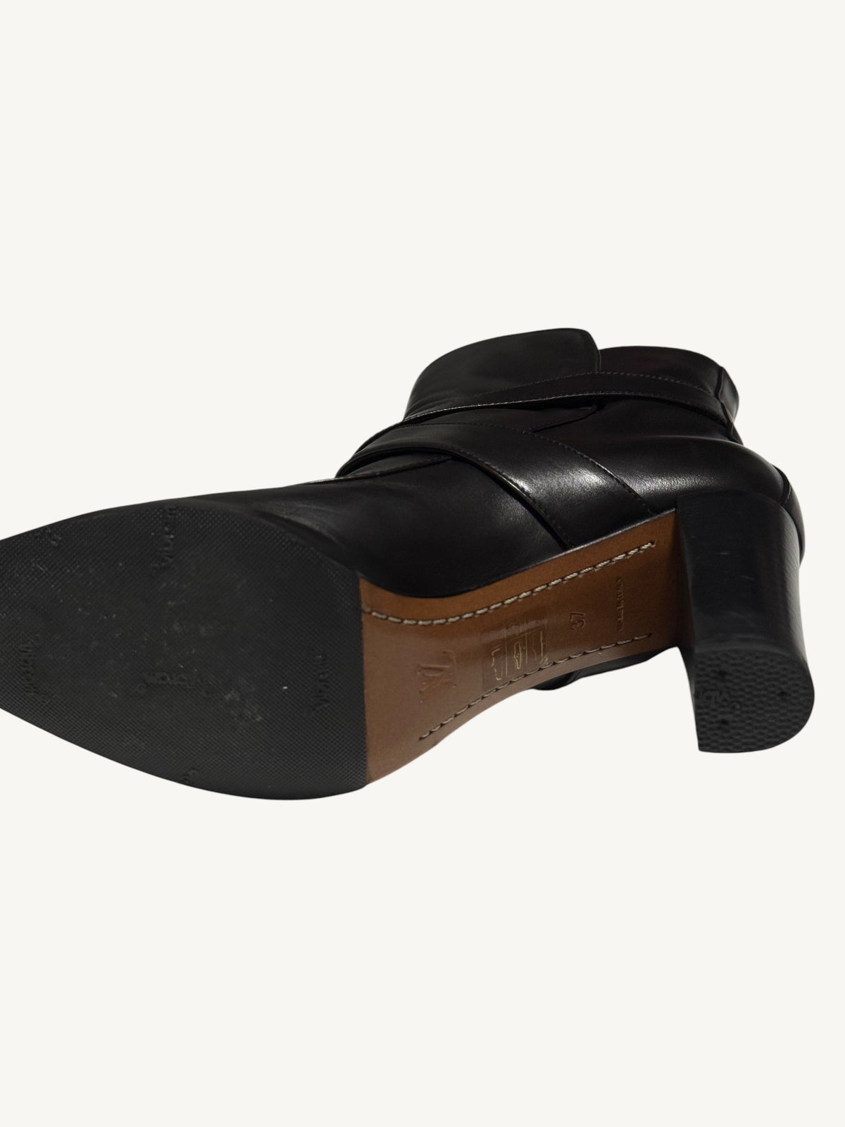 Angled underside of a Louis Vuitton boot, showing its rubber half-sole, stitched leather arch and heel cap.