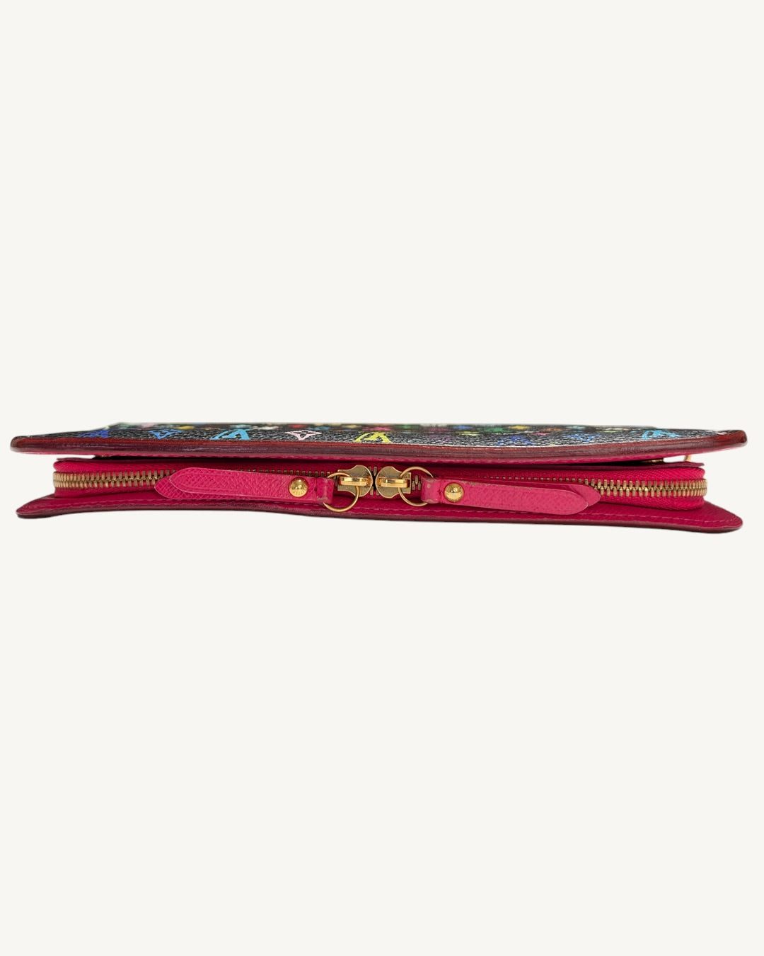 Side profile of the Louis Vuitton Insolite wallet showing two gold-tone zipper pulls with pink leather tabs.