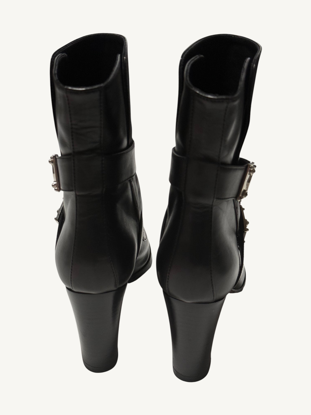 Rear view of black Louis Vuitton ankle boots, showing back seams, ankle straps and tall block heels.