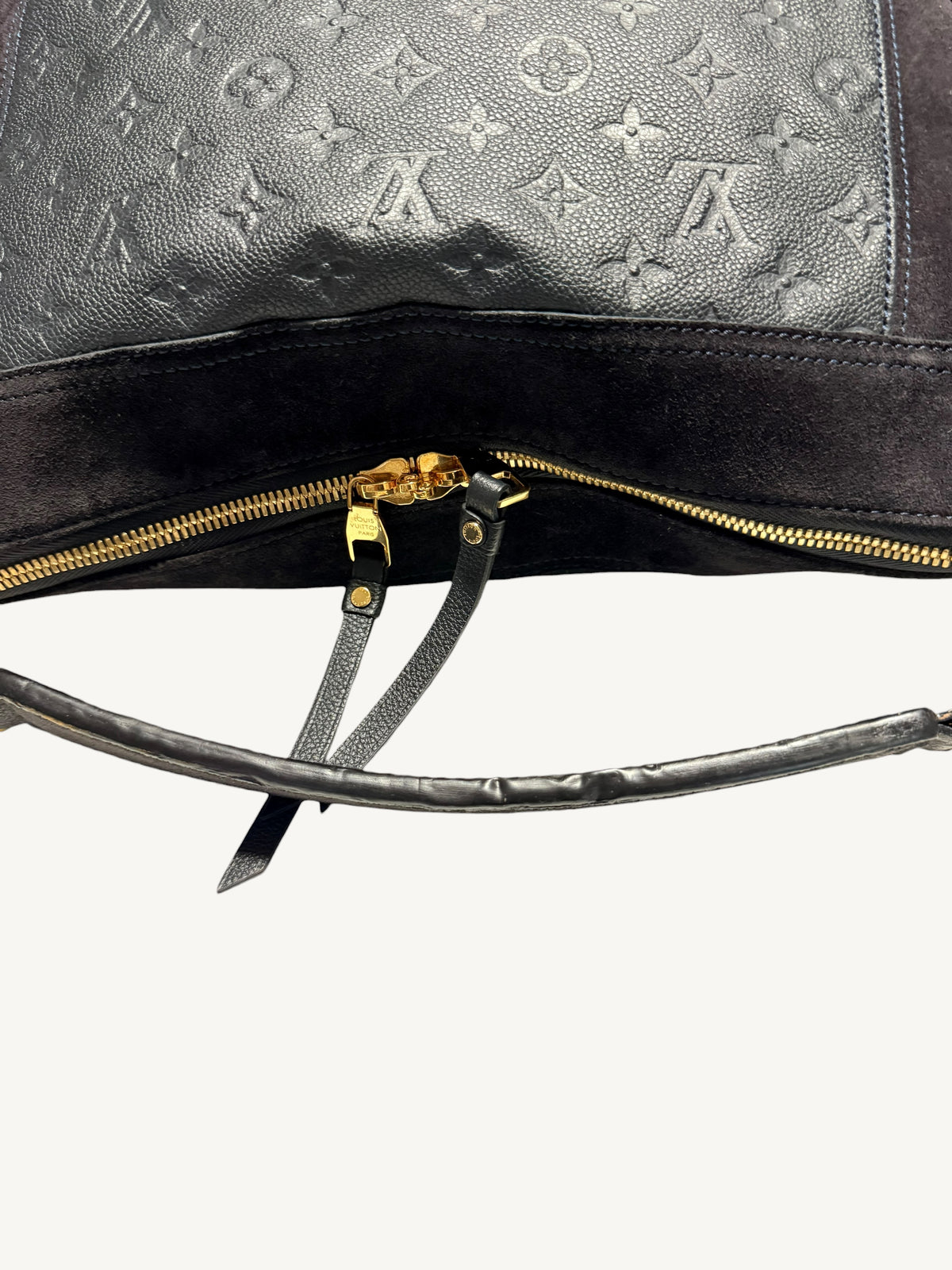 Louis Vuitton Audacieuse MM Infini — back view showing monogram empreinte embossing, double gold-tone zipper pulls and hand strap

