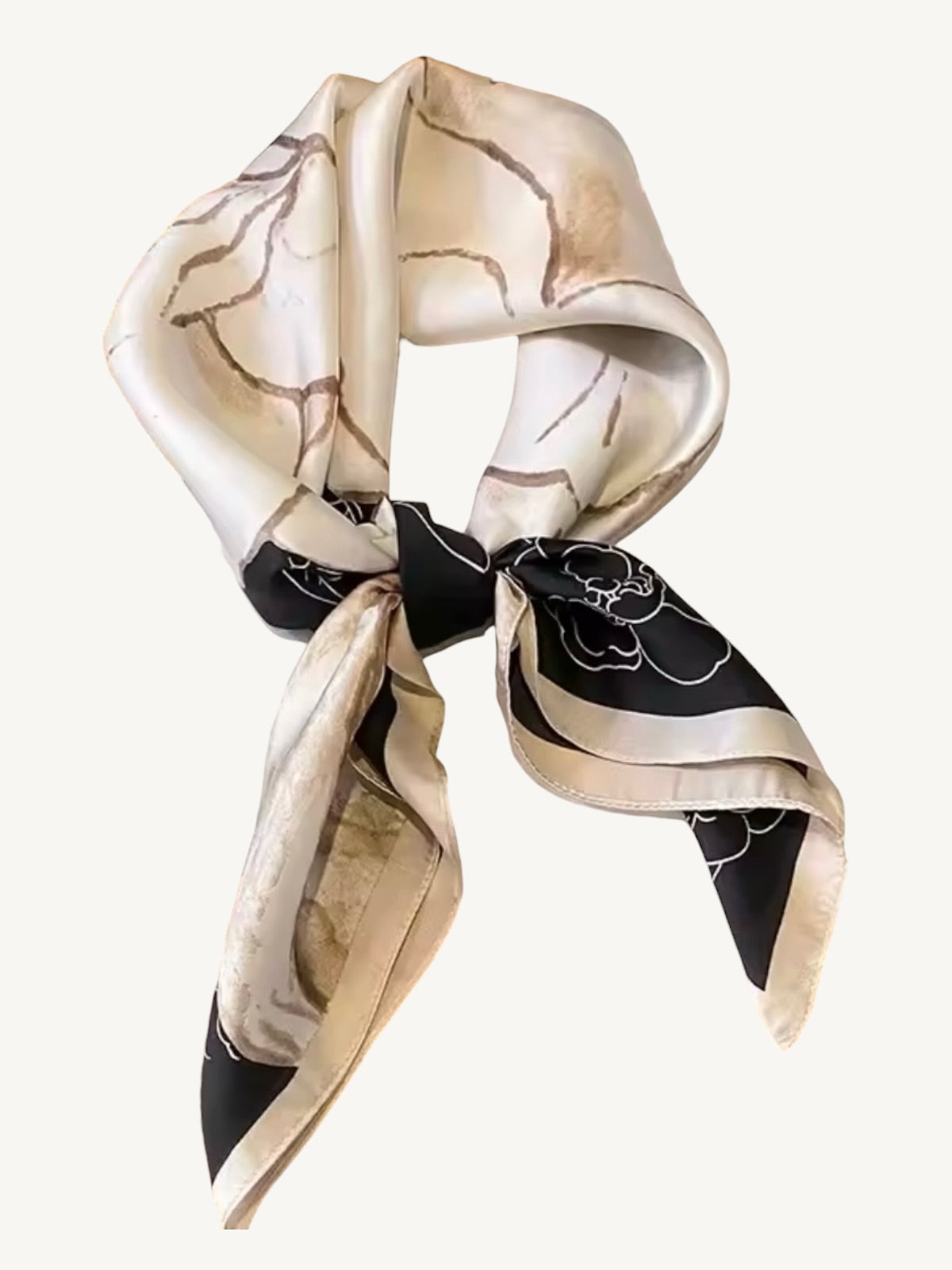 The Vendôme – square scarf tied in a knot showing camellia floral pattern and champagne border