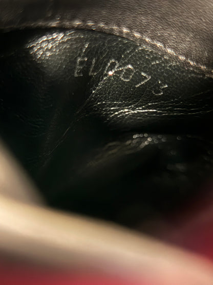 Close-up of the code EL0073 stamped inside the black leather boot beneath a stitched seam.