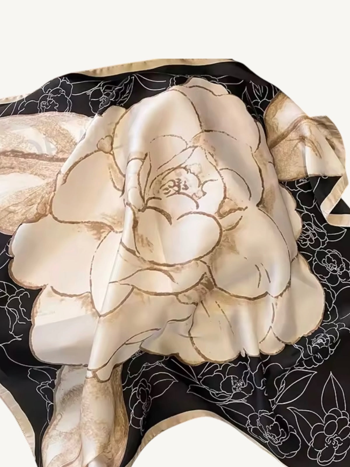 The Vendôme – close up of oversized camellia bloom in cream and champagne on black satin base