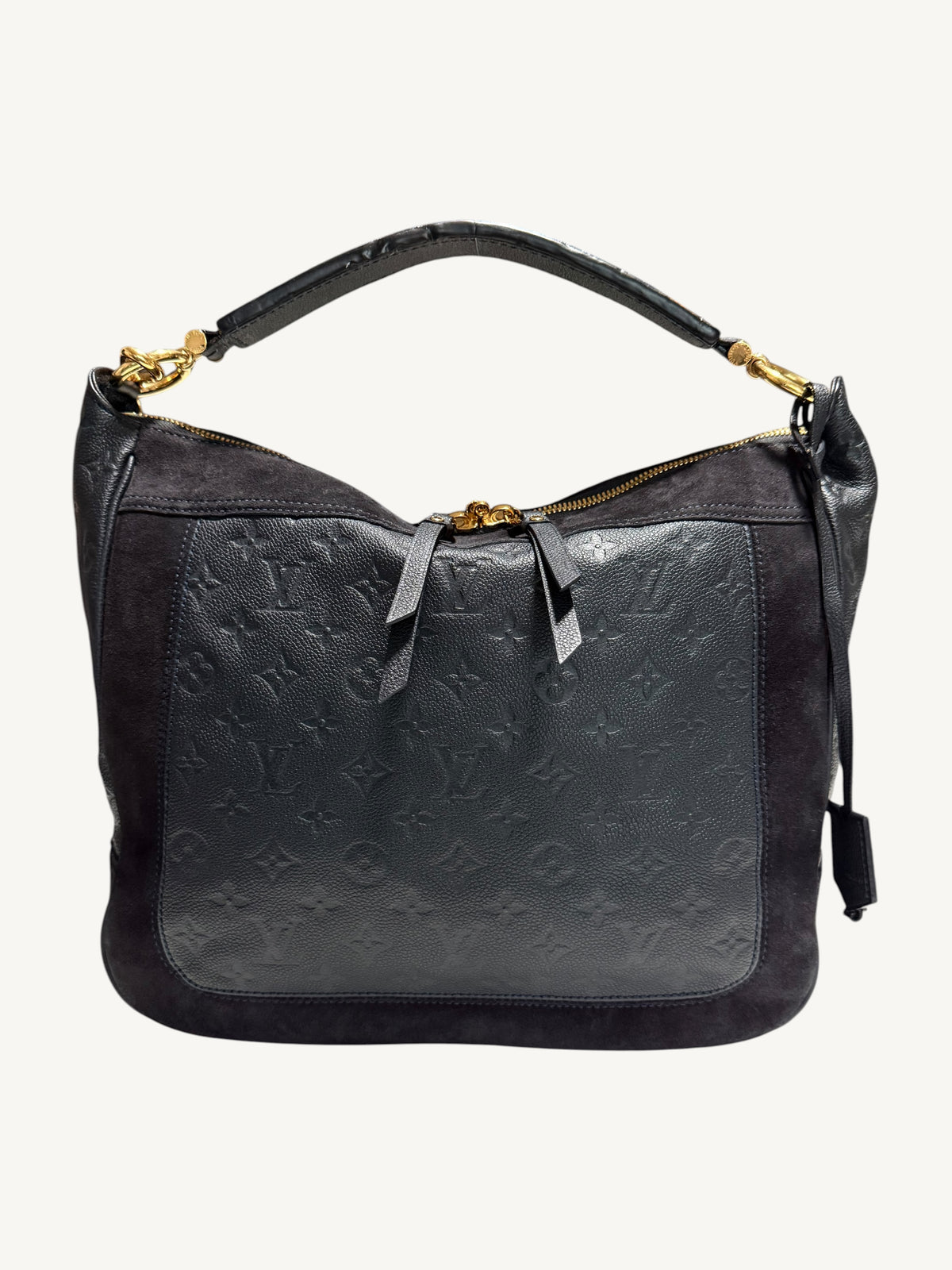 Louis Vuitton Audacieuse MM Infini — front view showing monogram empreinte embossed leather panel, tonal suede upper, flat leather top handle and gold-tone zipper hardware

