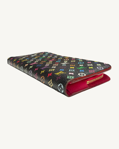 Angled view of the Louis Vuitton Insolite wallet showing black Multicolore canvas, pink leather edge and zipper.