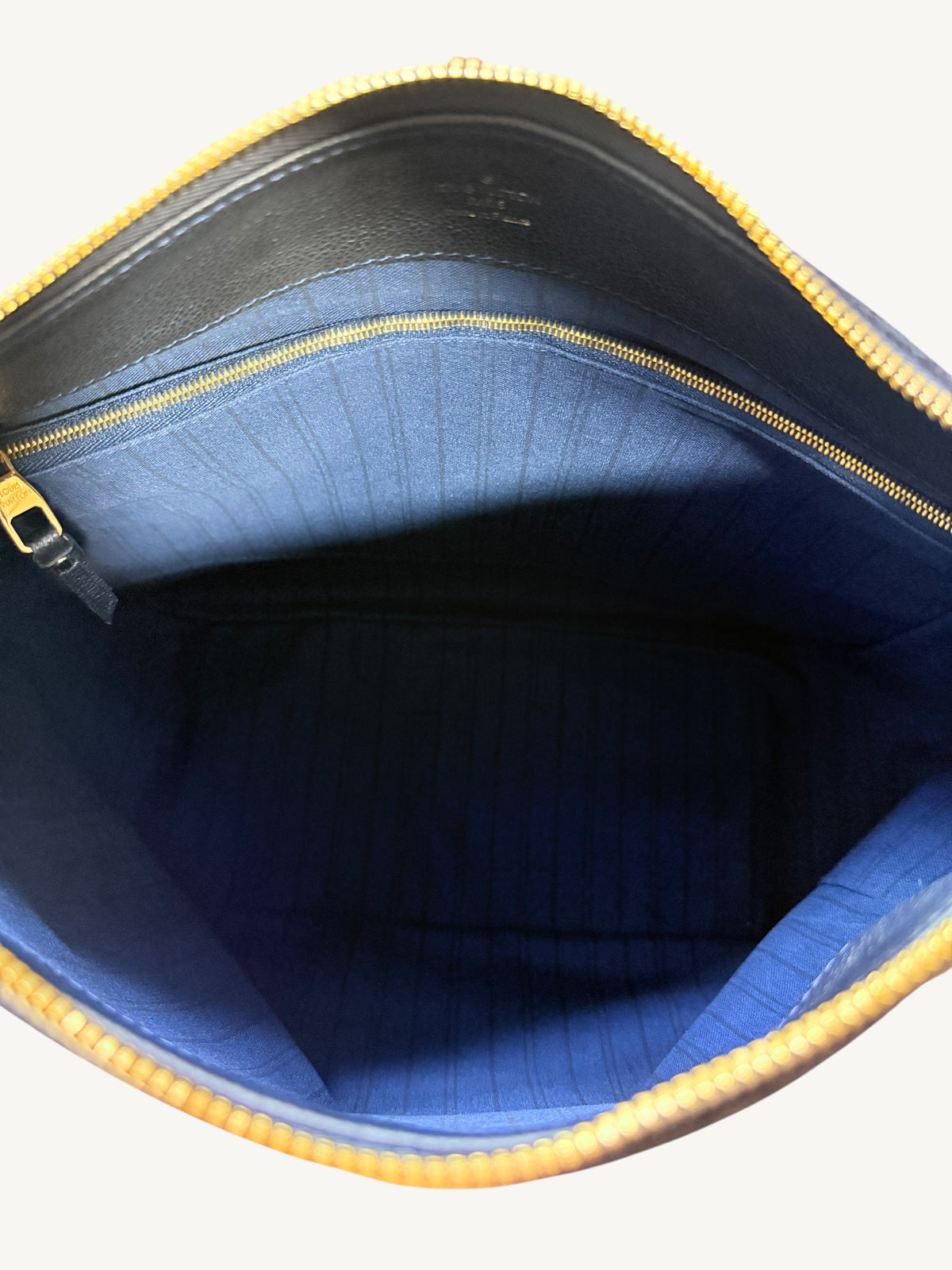 Louis Vuitton Audacieuse MM Infini — interior open showing blue striped canvas lining and gold-tone interior zipper pocket

