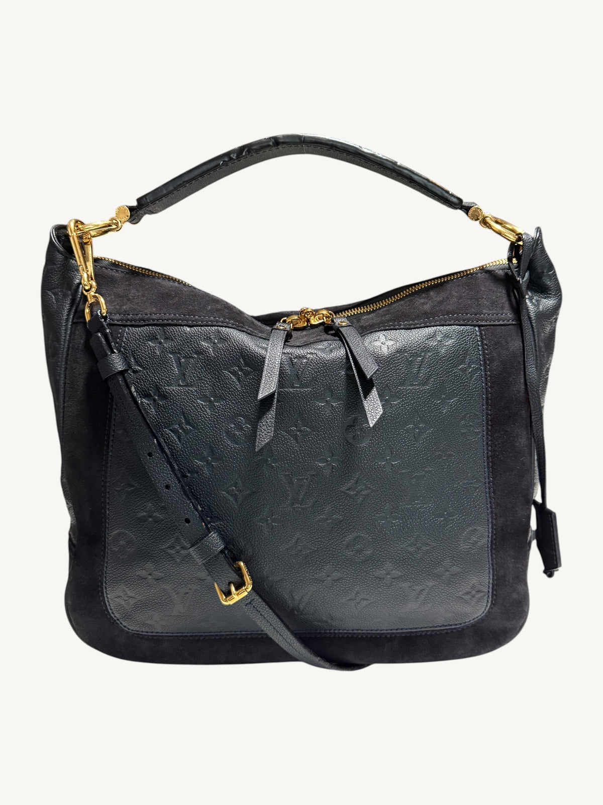 Louis Vuitton Audacieuse MM Infini — front view styled with detachable adjustable leather crossbody strap, showing gold-tone hardware and monogram empreinte leather panel

