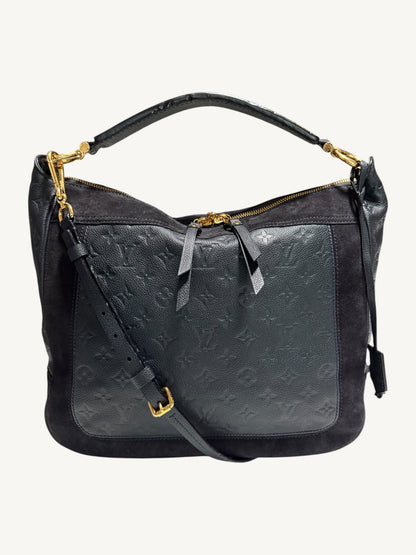 Louis Vuitton Audacieuse MM Infini — front view styled with detachable adjustable leather crossbody strap, showing gold-tone hardware and monogram empreinte leather panel

