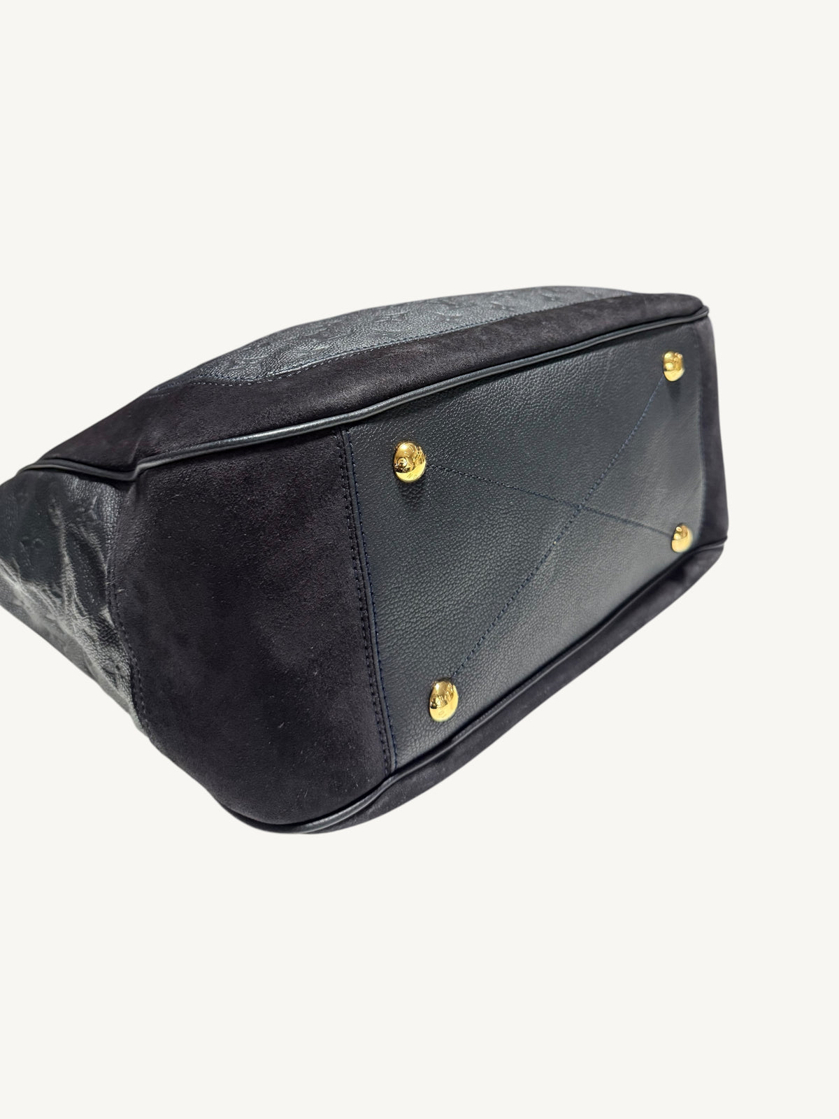 Louis Vuitton Audacieuse MM Infini — close-up front corner and base showing gold feet and suede-to-leather contrast