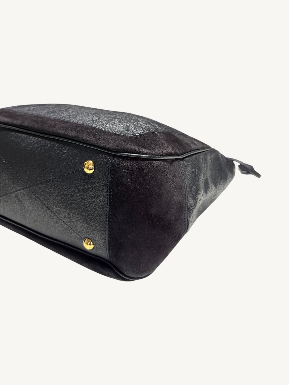 Louis Vuitton Audacieuse MM Infini — close-up front corner and base showing gold feet and suede-to-leather contrast