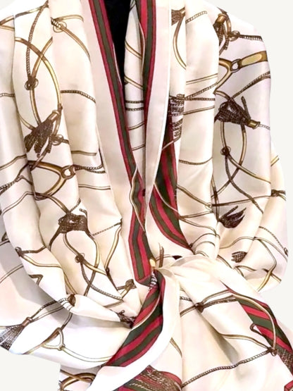 The Matera – ivory silky satin scarf shawl wrap showing full equestrian print with red and green striped border, draped on white background