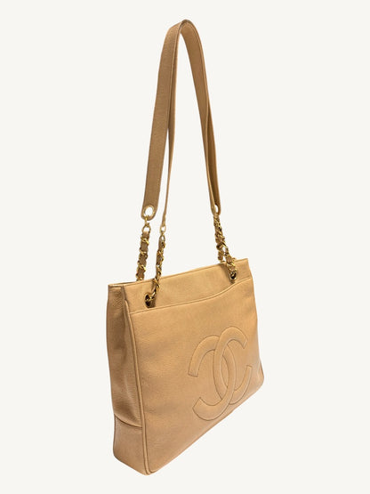 Opposite front angle of beige Chanel shoulder bag with stitched interlocking CC motif