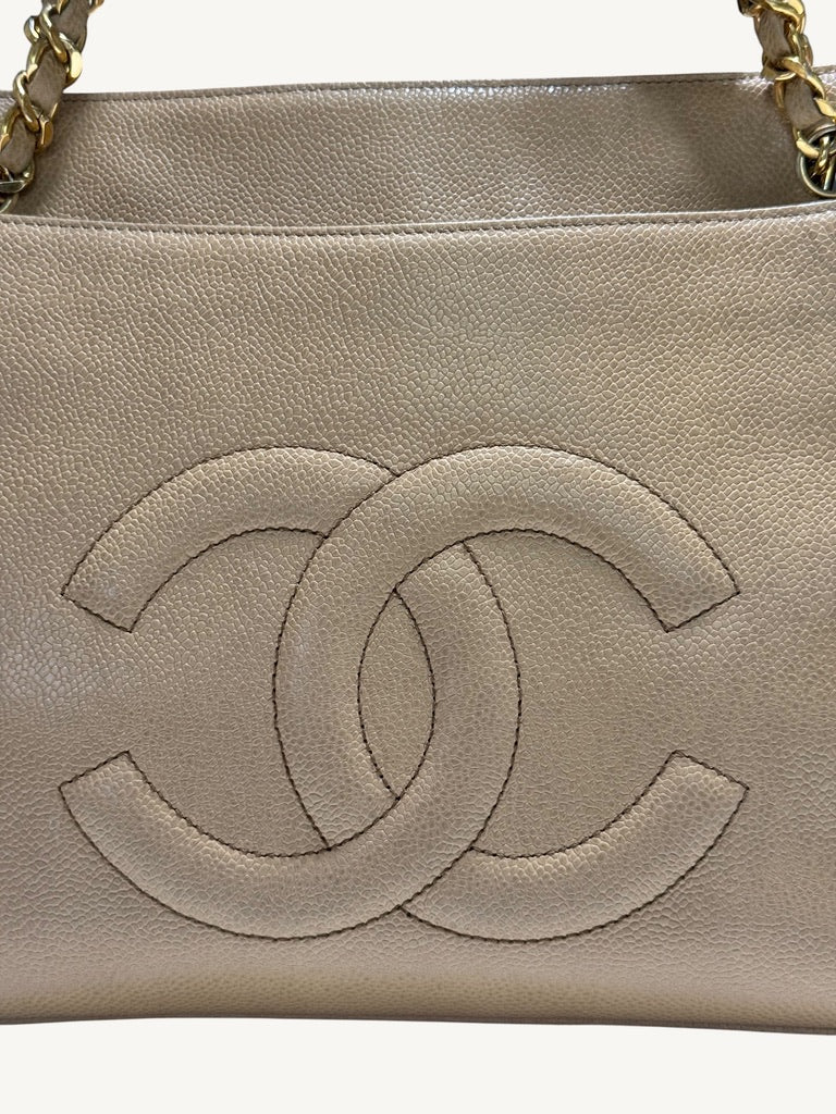 Detail of interlocking CC stitching and beige caviar leather texture