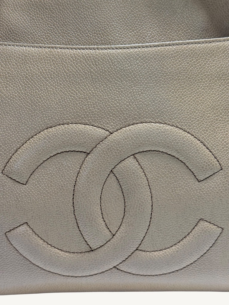 Close-up of oversized tonal CC motif beneath the exterior pocket seam