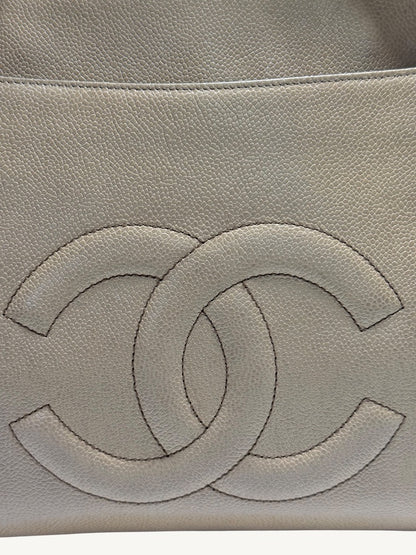 Close-up of oversized tonal CC motif beneath the exterior pocket seam