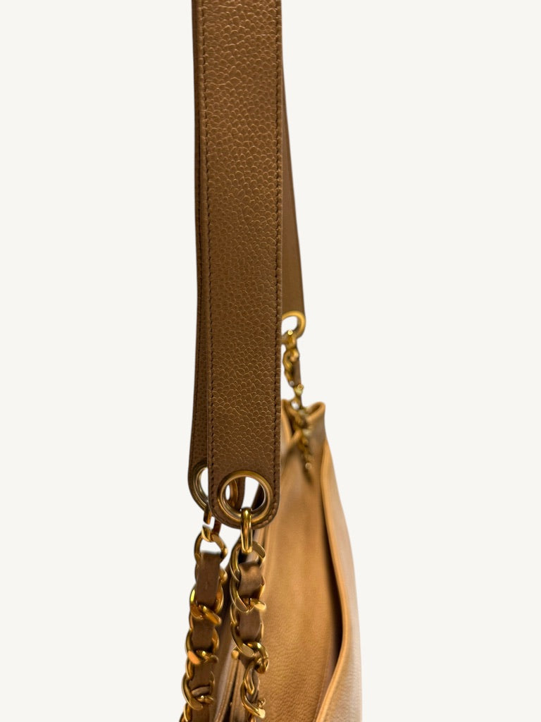Close-up of caviar shoulder pad and circular gold-tone strap grommet