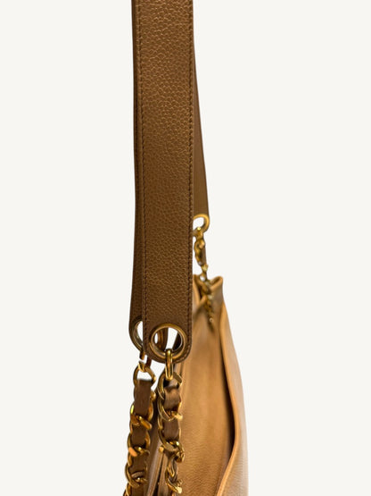 Close-up of caviar shoulder pad and circular gold-tone strap grommet
