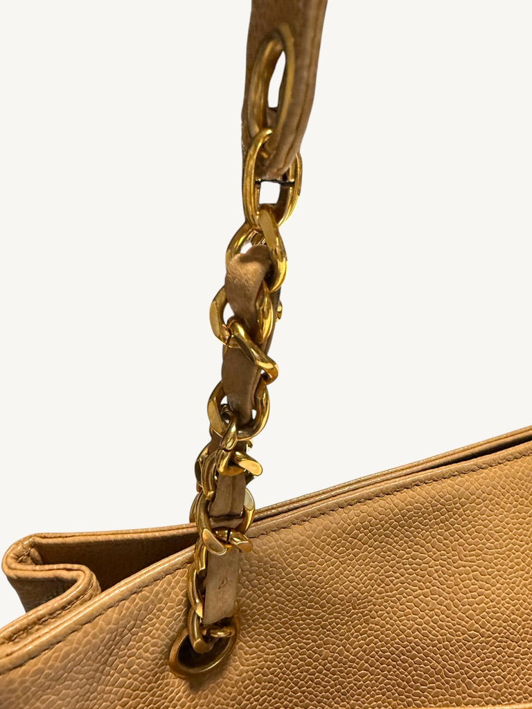 Leather-woven gold-tone chain and upper edge of Chanel tote