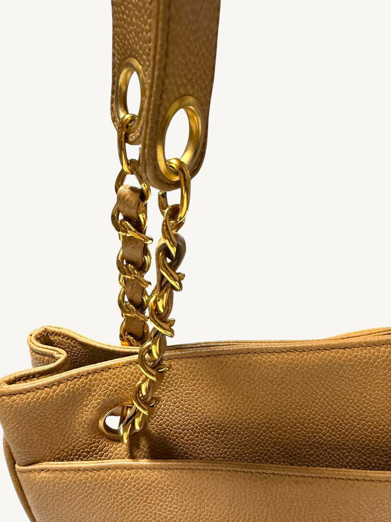 Opposite chain attachment with gold-tone rings and stitched leather trim