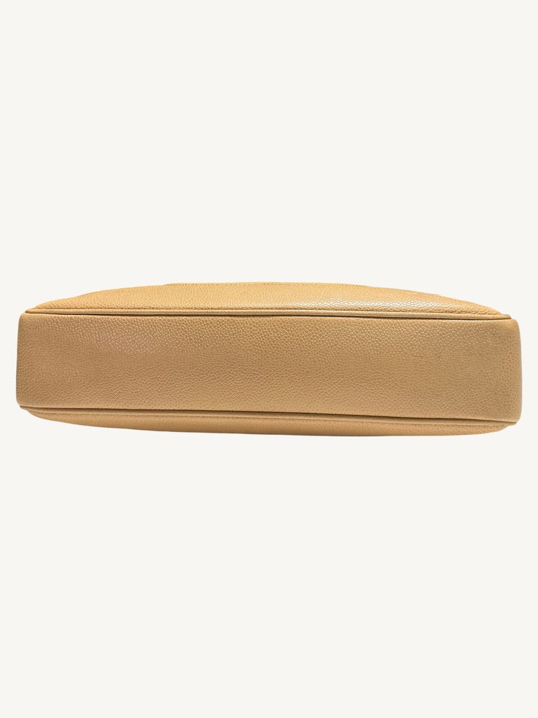 Full bottom view showing beige caviar leather base and piping