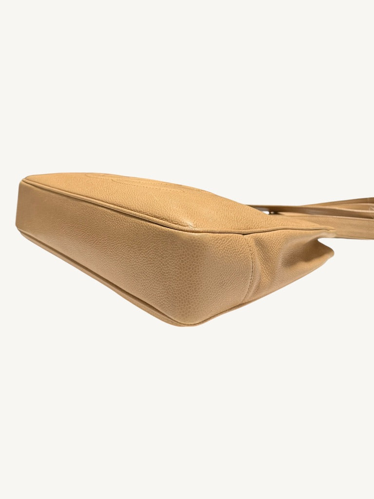 Angled bottom corner view documenting leather surface and piping condition