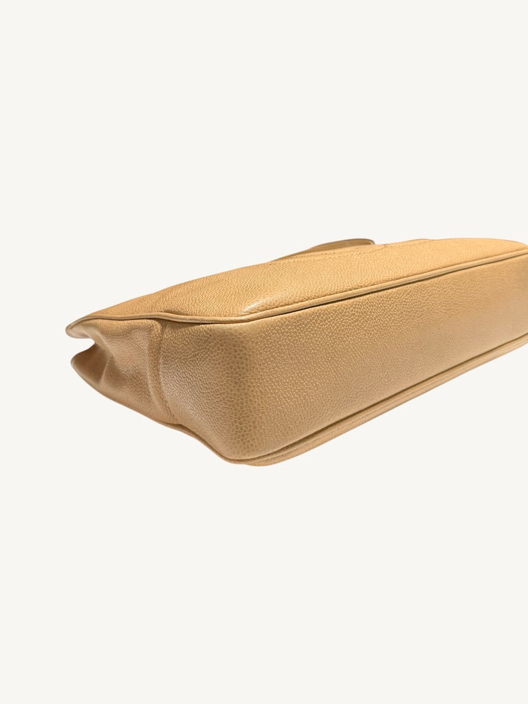 Opposite bottom corner and base seam of Chanel beige leather tote