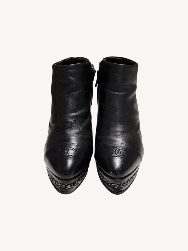 Front view of Chanel vintage black calfskin ankle boots showing embroidered interlocking CC cap toes