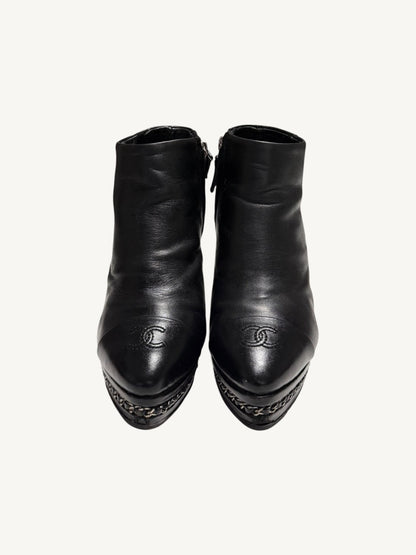 Front view of Chanel vintage black calfskin ankle boots showing embroidered interlocking CC cap toes