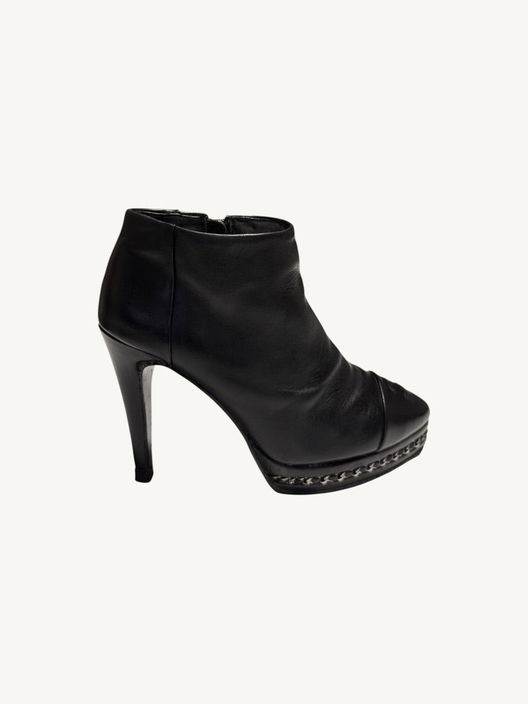 Outer side profile of Chanel vintage black calfskin chain platform stiletto ankle boot