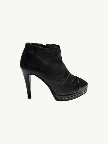 Outer side profile of Chanel vintage black calfskin chain platform stiletto ankle boot