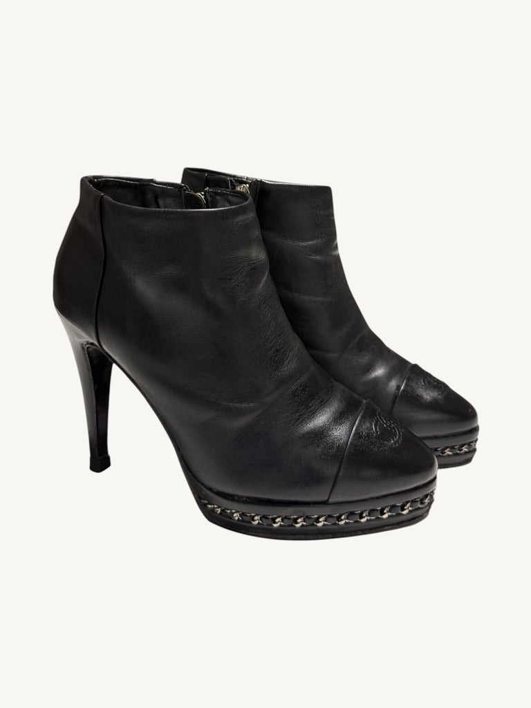 Chanel vintage black calfskin chain platform ankle boots, pair shown from a front three-quarter angle