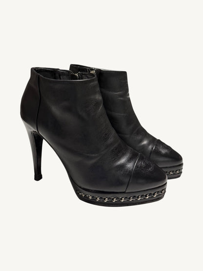 Chanel vintage black calfskin chain platform ankle boots, pair shown from a front three-quarter angle