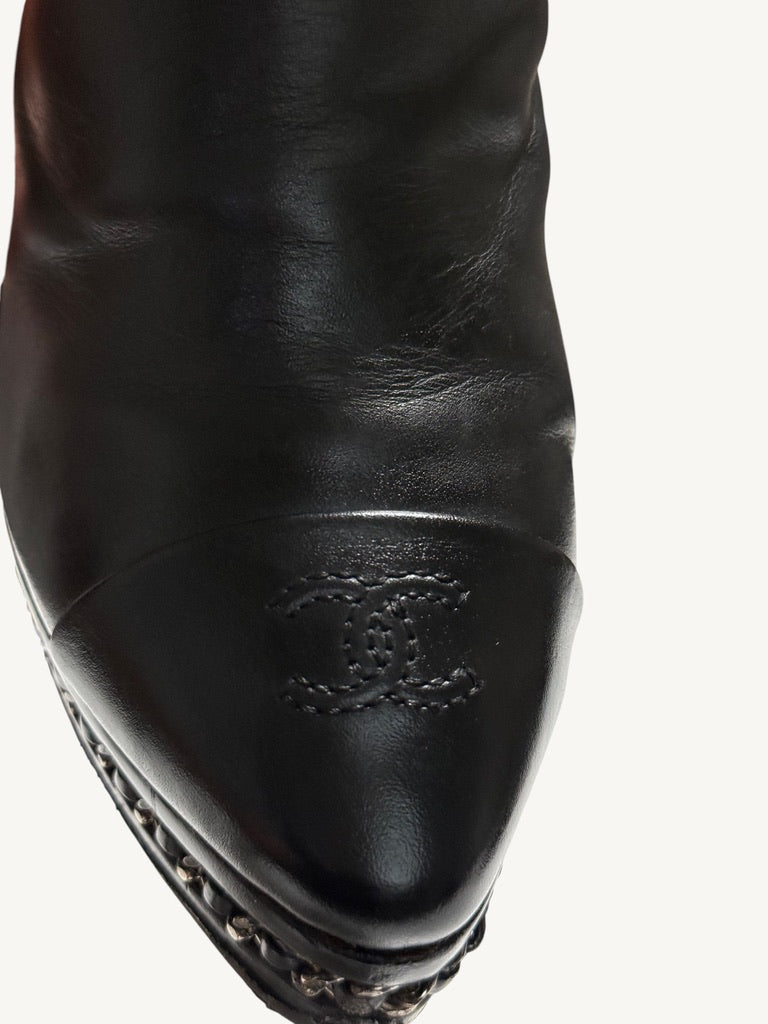 Close-up of stitched interlocking CC logo on Chanel vintage black calfskin ankle boot toe