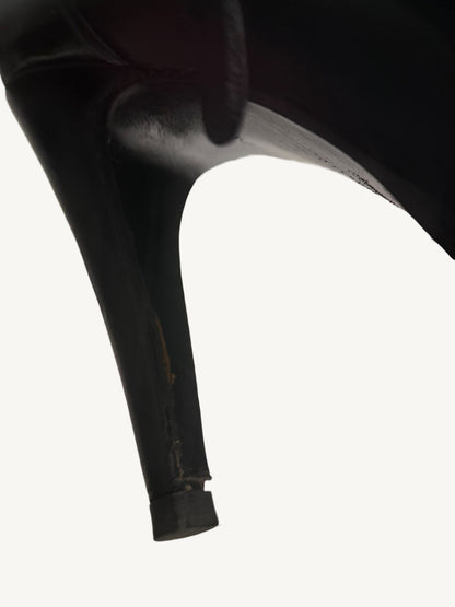Close-up of Chanel vintage black ankle boot heel base documenting leather wrap wear and seam
