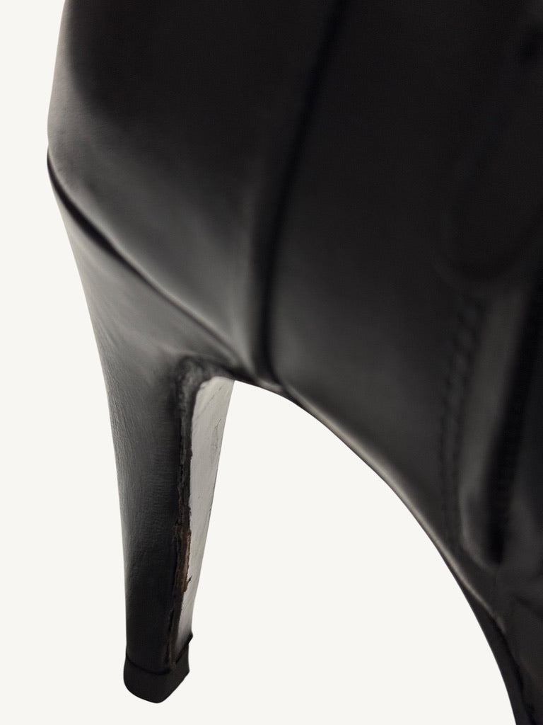 Close-up of leather-wrapped stiletto heel wear on Chanel vintage black ankle boot