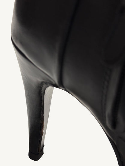 Close-up of leather-wrapped stiletto heel wear on Chanel vintage black ankle boot