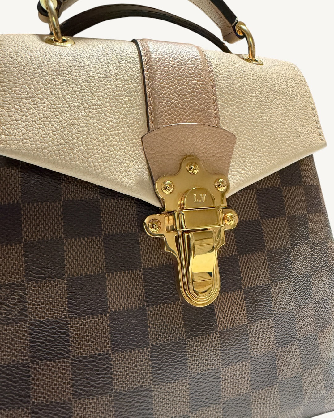 Louis Vuitton Clapton Backpack — Close-up of two-tone grained leather flap and gold-tone trunk-inspired closure