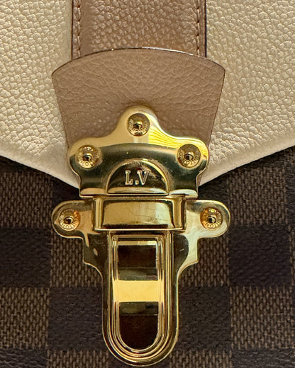 Louis Vuitton Clapton Backpack — Close-up of LV-engraved gold-tone clasp and warm taupe leather tab