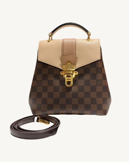 Louis Vuitton Clapton Backpack — Front view of backpack with removable brown leather strap coiled alongside